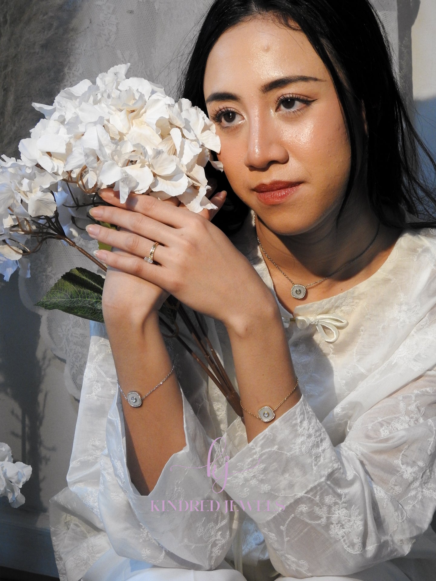 Woman holding a bouquet of white flowers with a blurred background